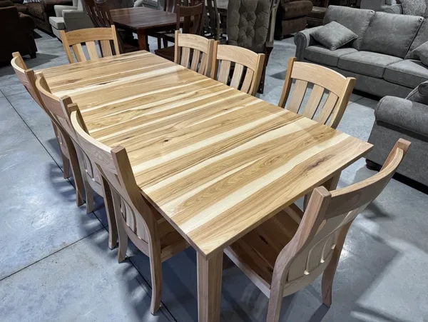 A rectangular dining table and six matching chairs constructed from light-colored wood with a distinctive, high-contrast striped grain pattern